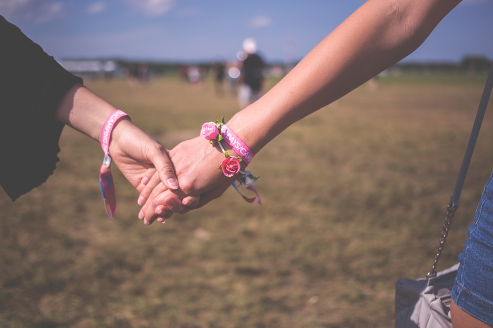 red and pink floral bracelet holding hands preview
